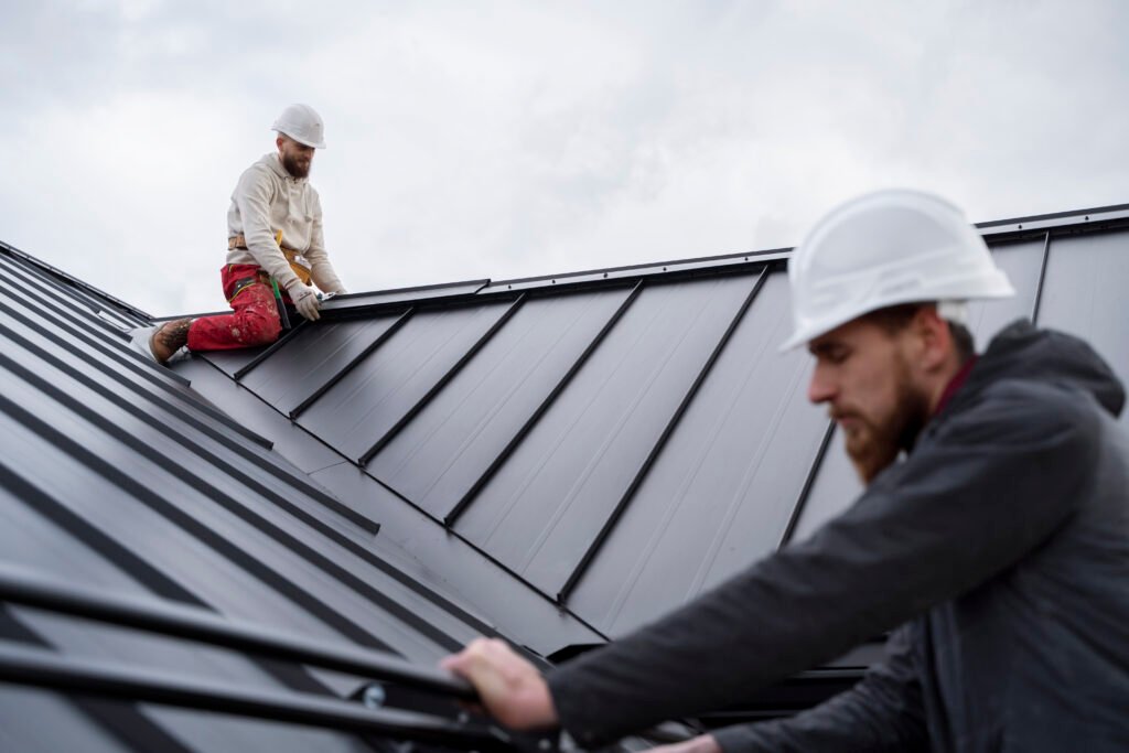 medium shot men working roof | Vanhook Roofing and Exteriors